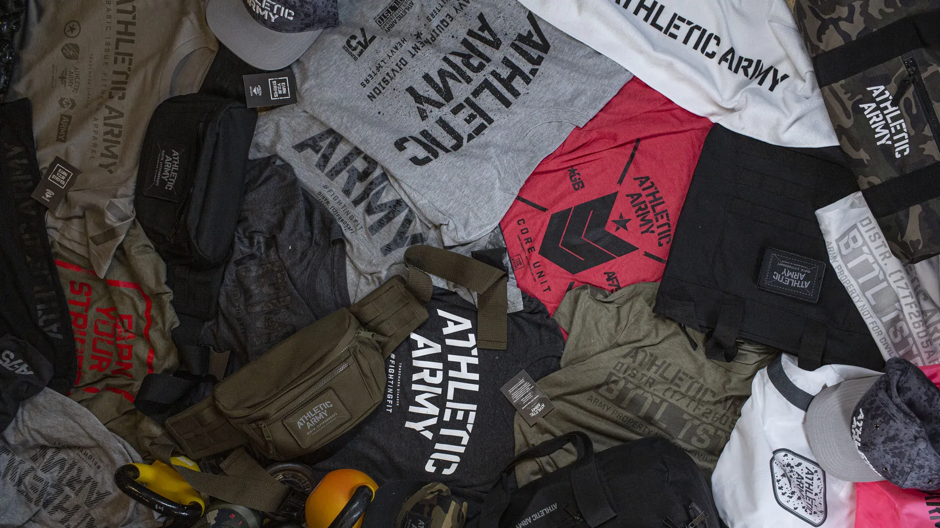 Athletic Army kit laid out: tees, caps, waist bags and holdalls